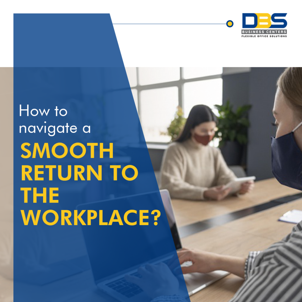 People wearing masks working at a large table in a well-lit office, emphasizing safe workplace return